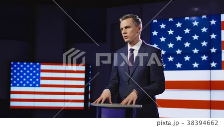 Presenter in front of American flag Presenter in front of American flag 38394662