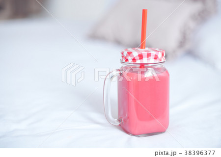 glass bottle with fresh red smoothies 38396377