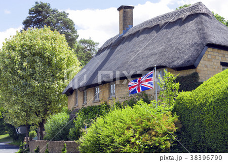 stone house in village with flying British flag 38396790