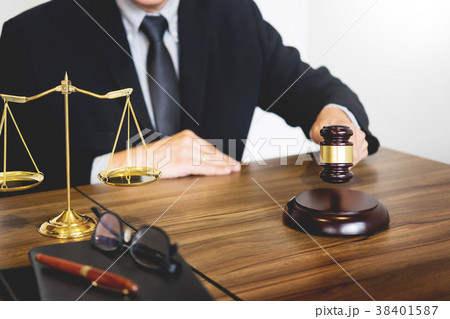 Male Judge lawyer In A Courtroom Striking The Gavel on sounding Male Judge lawyer In A Courtroom Striking The Gavel on sounding 38401587