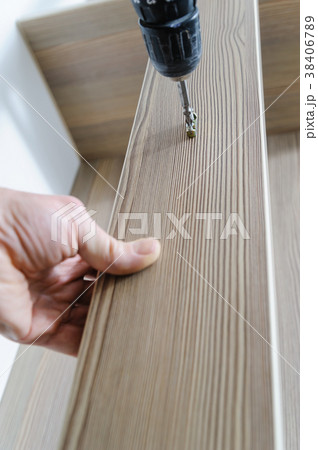 A man is installing a hook. 38406789