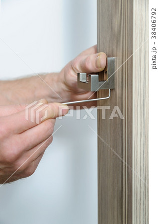 A man is installing a hook. 38406792