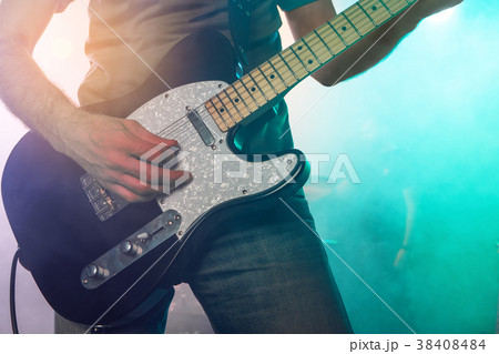 The guitarist performs on stage. The guitarist performs on stage. 38408484