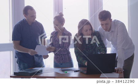 Group of people at the working place in a stylish Group of people at the working place in a stylish 38412290