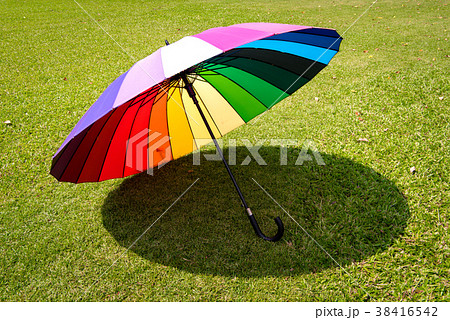 rainbow umbrella in grass field rainbow umbrella in grass field 38416542