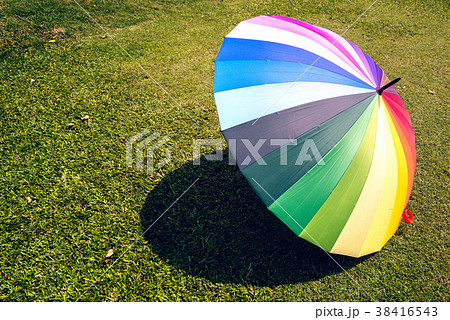 rainbow umbrella in grass field rainbow umbrella in grass field 38416543