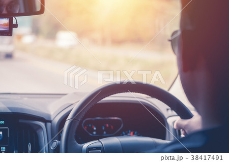 Driver hands holding steering wheel, inside of a 38417491