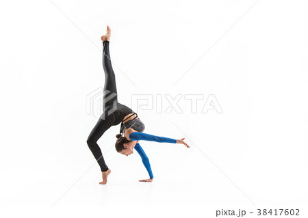 young sporty woman doing acrobatic exercise young sporty woman doing acrobatic exercise 38417602