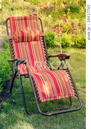 Chaise-longue in the summer sunny garden. Chaise-longue in the summer sunny garden. 38417762