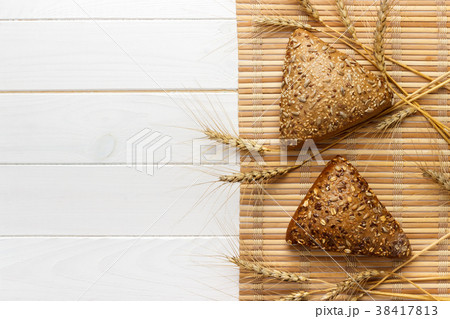 Several small multi grain triangular shaped bread 38417813