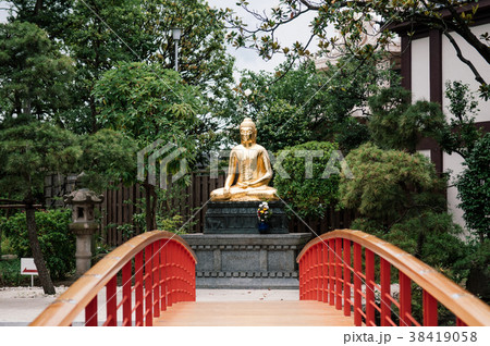 Japanese garden red bridge golden Buddha statue Japanese garden red bridge golden Buddha statue 38419058