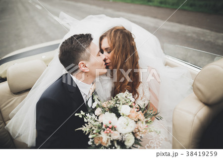 Stylish wedding couple, bride, groom kissing and 38419259