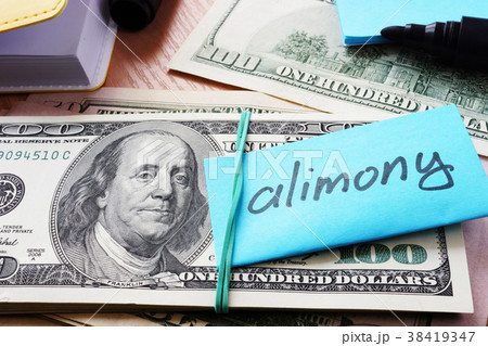Pile of dollars with word alimony on a stick. 38419347