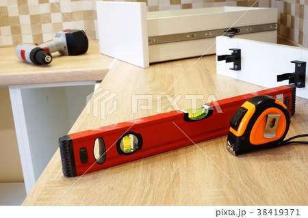 Installation of furniture in the kitchen.  38419371