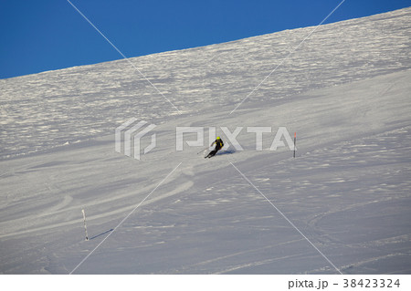 Skier skiing downhill in mountains Skier skiing downhill in mountains 38423324