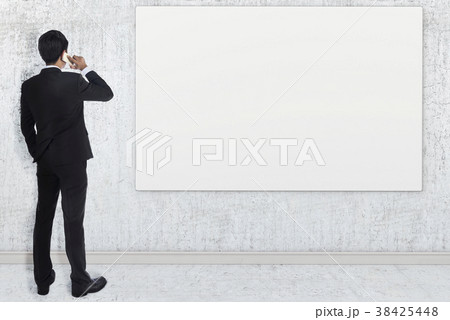 Businessman watching blank poster. 3D render Businessman watching blank poster. 3D render 38425448