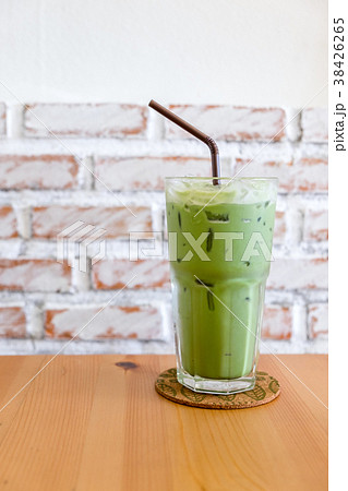 glass of iced green tea with milk on wooden table glass of iced green tea with milk on wooden table 38426265