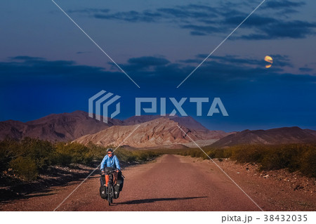 Woman cycling at night 38432035