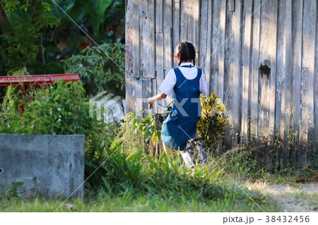 Asian student girl wearing uniform,enjoy a bicycle 38432456