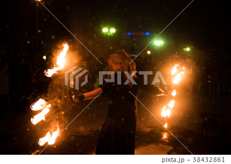 Girl with fire fan, in the dark Girl with fire fan, in the dark 38432861