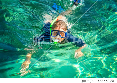 Woman snorkeling in clear ocean waters 38435178