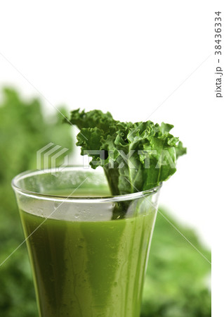 kale smoothie in a glass topped with a kale leaf 38436334