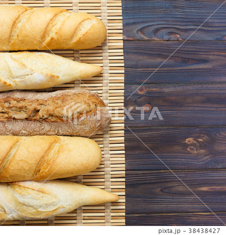 Freshly baked French baguettes on white table Freshly baked French baguettes on white table 38438427