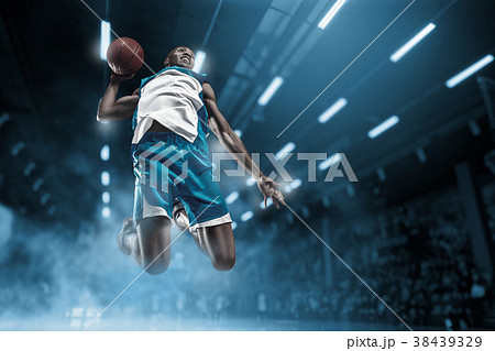 Basketball player on big professional arena during Basketball player on big professional arena during 38439329