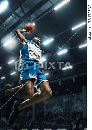 Basketball player on big professional arena during 38439330