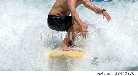 Surfer rides what water r 38440876