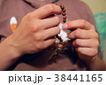 Female hands holding wooden rosary. Close up 38441165