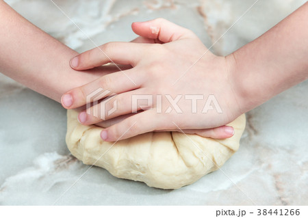 Children hands kneads dough Children hands kneads dough 38441266