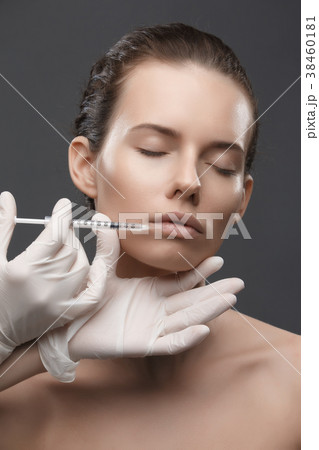 Portrait of young Caucasian woman getting cosmetic Portrait of young Caucasian woman getting cosmetic 38460181