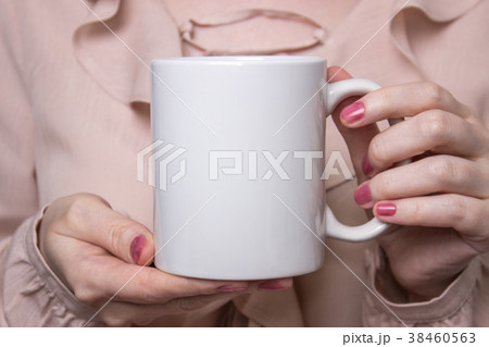 Girl is holding white cup in hands. White mug for 38460563