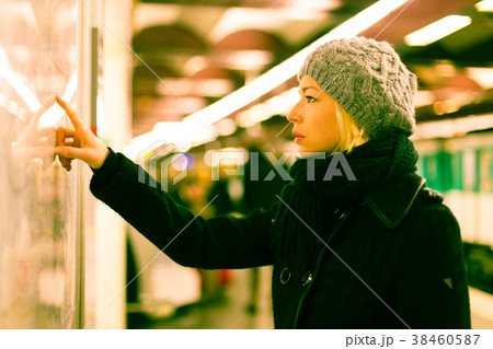 Lady looking on public transport map panel. 38460587