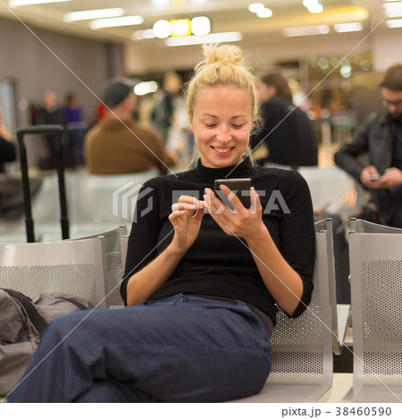 Lady using smart phone while waiting at airpot 38460590