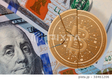 Crack bitcoin and background dollar banknote. Crack bitcoin and background dollar banknote. 38461206