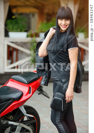 Girl biker in black clothes on a sports motorcycle Girl biker in black clothes on a sports motorcycle 38463247