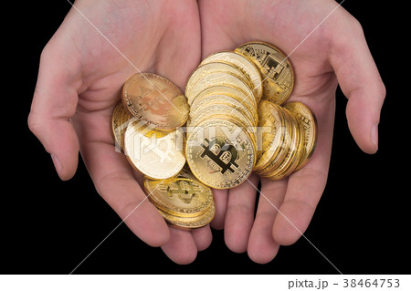 hand holding a pile of golden bitcoins 38464753