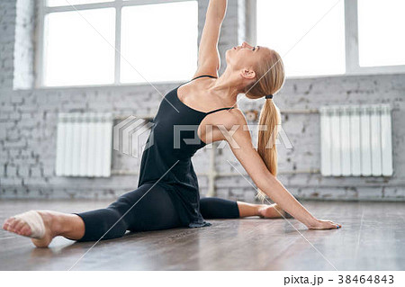 Young woman in sportswear doing stretching 38464843