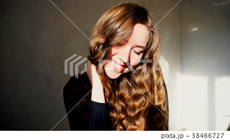 Young Female Smiling, Looking at Camera with curly 38466727