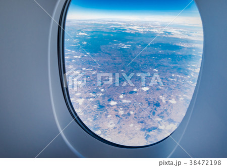 airplane window when flying see through at cloud 38472198