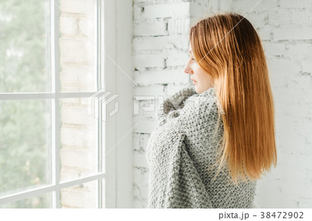 Pretty Redhead Woman Looking out the Window 38472902