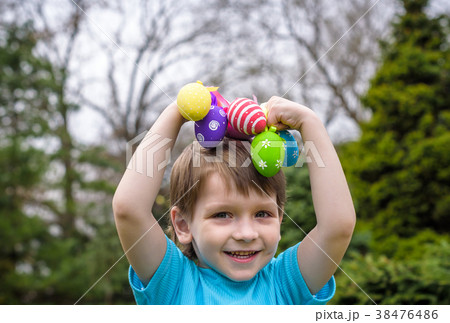 Kids on Easter egg hunt in blooming spring garden. Kids on Easter egg hunt in blooming spring garden. 38476486