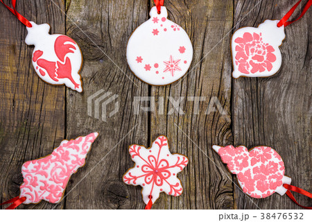 Gingerbread cookies over wooden background 38476532