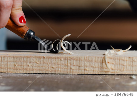 close-up carpenter woman's hand with a red 38476649