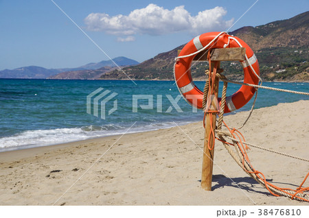 Life preserver on sandy beach somewhere near at Life preserver on sandy beach somewhere near at 38476810