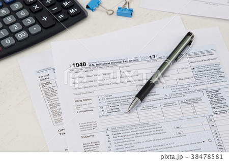 US tax form 1040 with pen and calculator US tax form 1040 with pen and calculator 38478581