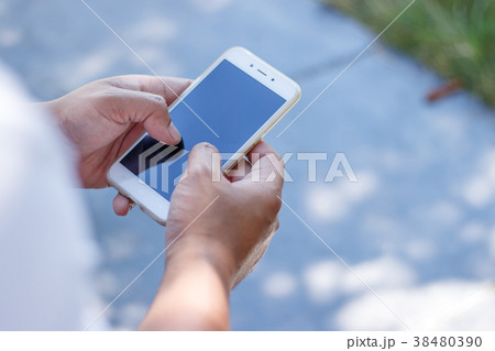 Male hands using smartphone. 38480390