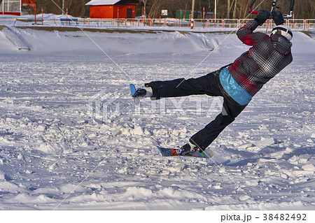 A male athlete engaged in snow kiting 38482492